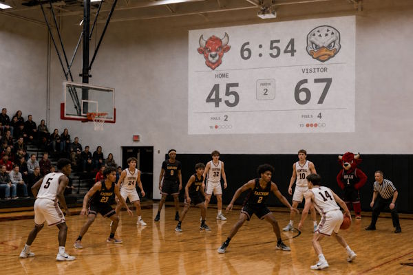 NBA basketball scoreboard projected on a gym wall during a match